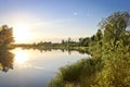 Summer background - calm river among birch groves, sunset over the river. Summer landscape Royalty Free Stock Photo