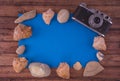 Summer background-the concept of summer holidays on the tropical beach. retro camera with seashells from the sea on a wooden table Royalty Free Stock Photo