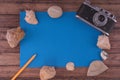 Summer background-the concept of summer holidays on the tropical beach. retro camera with seashells from the sea on a wooden table Royalty Free Stock Photo