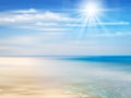 Summer background with ocean, coastline, blue sky, sunshine and beach.