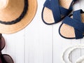 Summer background Straw hat Bracelets Sandals sunglasses on a white table Copy space Royalty Free Stock Photo