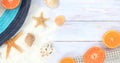 Summer banner with a hat, white mesh, shells and starfish on a wooden light background Royalty Free Stock Photo