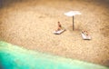 Summer background sunbather couple in deserted beach sunbathing with copy space