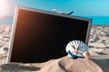 Summer background table. Globe, seashell, airplane and starfish near black desk on sea beach in sunny day. Copy space of Royalty Free Stock Photo