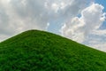 Summer background. warm sunny weather on a green grass hill. A blue sky with white clouds. Royalty Free Stock Photo