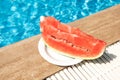 Summer background with watermelon near swimming pool. Hot summer travel, vacation and holiday concept Royalty Free Stock Photo