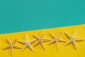 Summer background of yellow and blue paper with starfish, symbol Royalty Free Stock Photo