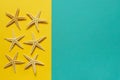 Summer background of yellow and blue paper with starfish, symbol Royalty Free Stock Photo