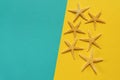 Summer background of yellow and blue paper with starfish, symbol Royalty Free Stock Photo