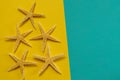 Summer background of yellow and blue paper with starfish, symbol Royalty Free Stock Photo