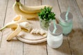 Summer banana smoothie or milkshake with mint and straw in jars on dark wooden tablen with copy space