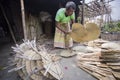 A worker is busy in making hand held fan.