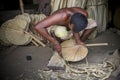 A worker is busy in making hand held fan.
