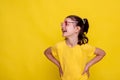 summer banner crazy seasonal sale of children clothes. child girl in mockup yellow T-shirt on yellow background Royalty Free Stock Photo