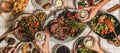 Flat-lay of peoples hands with glasses over barbeque party table