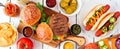 Summer BBQ food table scene with hot dog and hamburger buffet, top down view banner over white wood Royalty Free Stock Photo