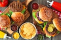 Summer BBQ hamburger table scene, above view over wood