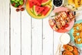 Summer BBQ or picnic food corner border, above view over a white wood background Royalty Free Stock Photo