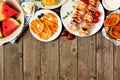 Summer BBQ or picnic food top border, above view over a wood background Royalty Free Stock Photo