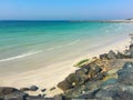 Summer beach background. Rocky beach with black stones. White b Royalty Free Stock Photo