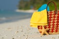 Summer beach bag with shell, towel on sandy beach Royalty Free Stock Photo