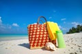 Summer beach bag with shell, towel on sandy beach Royalty Free Stock Photo