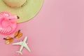Summer beach composition. Minimal simple flat lay with plane sunglasses hat and Inflatable flamingo isolated on pastel pink