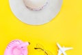 Summer beach composition. Minimal simple flat lay with plane sunglasses hat and Inflatable flamingo isolated on yellow background