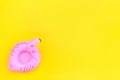 Summer beach composition. Simply minimal design with pink Inflatable flamingo isolated on yellow background. Pool float party,