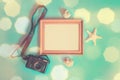 Summer beach holiday concept. Photo frame, photo camera, starfish and seashells on blue background Royalty Free Stock Photo