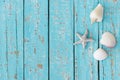 Maritime summer background with sea star and seashells on turquoise blue wood