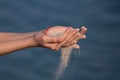 Summer beach holiday vacation concept. Hands releasing dropping sand. Outdoor