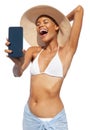 Summer beach holiday a woman showing screen of mobile phone she's wearing a bikini and sun hat, isolated on a white Royalty Free Stock Photo