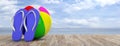 Summer beach vacation. Flip flops and beach ball on wooden deck, blue sea and sky background, banner, copy space. 3d illustration Royalty Free Stock Photo