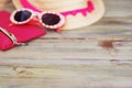 Summer Beach Holliday Concept. Straw Female Hat and Sunglasses on a light Wooden background. Selective focus. Copy Space.