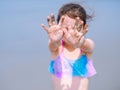 Summer beach - Little girl have a good time of resort beach. Kid playing on sandy beach. Focus on the hand Royalty Free Stock Photo