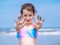 Summer beach - Little girl have a good time of resort beach. Kid playing on sandy beach. Focus on the hand Royalty Free Stock Photo