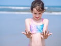 Summer beach - Little girl have a good time of resort beach. Kid playing on sandy beach. Focus on the hand Royalty Free Stock Photo