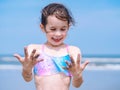 Summer beach - Little girl have a good time of resort beach. Kid playing on sandy beach. Focus on the hand Royalty Free Stock Photo