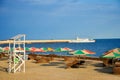 Summer beach near the sea - trestle beds, umbrellas for shade, l Royalty Free Stock Photo