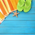 Summer beach objects border, flip flops, starfish blue wood background copy space Royalty Free Stock Photo