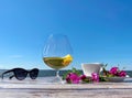 Summer beach restaurant glass of juice sunglasses and cup of coffee with roses flowers on table top ,horizon sea and blue sky at b Royalty Free Stock Photo