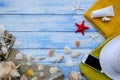 Summer beach sea concept. Blue Wooden background with different accessories, shells, starfish, towel, sunscreen, sand Royalty Free Stock Photo