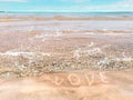 Summer beach sea light  on sand love lettering  text romantic sun reflection on ocean water white fluffy clouds at sky  beautiful Royalty Free Stock Photo