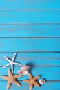 Summer beach seashore background starfish blue old wood vertical Royalty Free Stock Photo