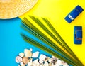 Summer Beach Travel concept. Palm Tree Leaf, straw hat, seashell, blue car on yellow background