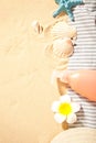 Summer beach, travel, holiday, vacation concept. Tube of sunscreen, starfish, plumeria frangipani and seashells on the