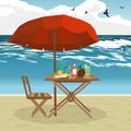 Summer on the beach: umbrella, sun, table, cocktail, coconut. Royalty Free Stock Photo