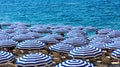 Summer beach umbrellas along Promenade des Anglais boulevard along Nice Mediterranean Sea shore on French Riviera in France Royalty Free Stock Photo