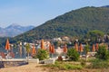 Summer beach vacation. Beautiful Mediterranean landscape with beach umbrellas on sunny summer day. Montenegro, Bay of Kotor Royalty Free Stock Photo